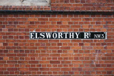 Close-up of text on brick wall