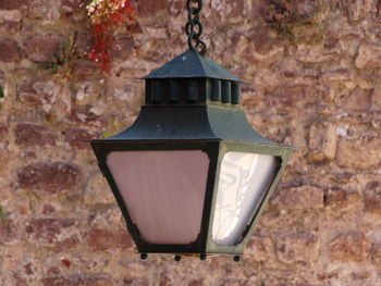 Close-up of lantern hanging on wall