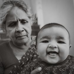 Portrait of cute baby girl with grandmother