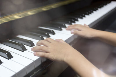 Close-up of woman playing piano