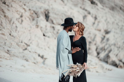 Couple embracing while standing at desert