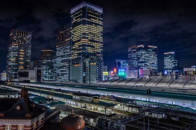 High angle view of illuminated buildings against sky at night