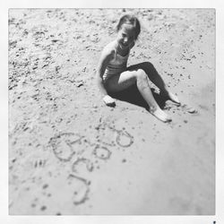 Full length of woman sitting on beach