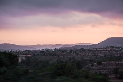Scenic view of landscape against sky at sunset