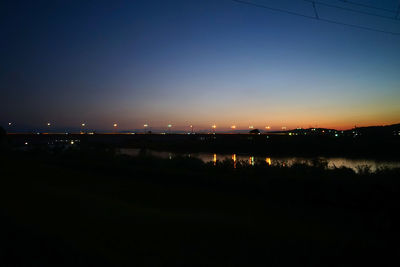 Illuminated city against sky at night