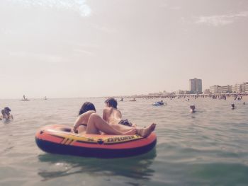 People on beach against sky