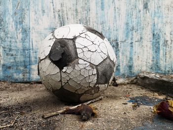 Close-up of old ball on stone wall