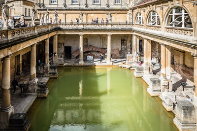 Tourist at roman baths on sunny day