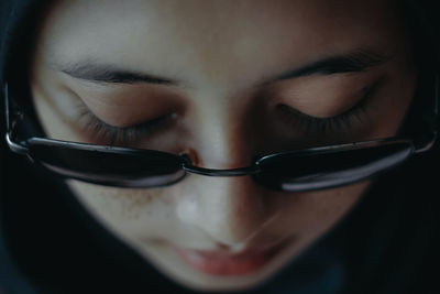 Close-up high angle view of young woman wearing eyeglasses