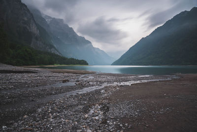 Scenic view of mountains against cloudy sky