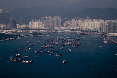 High angle view of cityscape by sea against sky