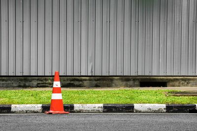 Road sign against wall