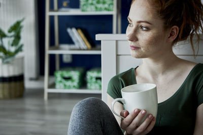 Man drinking coffee cup at home