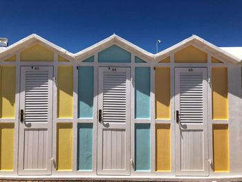 Low angle view of beach huts against sky