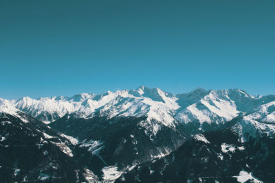 Scenic view of snow mountains against clear blue sky