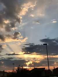 Low angle view of silhouette buildings against dramatic sky