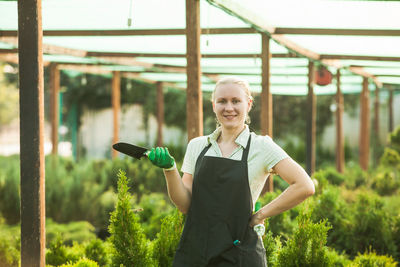 Portrait of smiling young woman standing outdoors