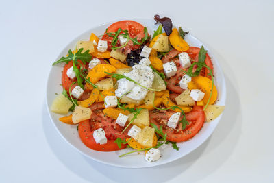 High angle view of chopped fruits in plate on table