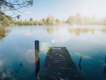 Scenic view of pier on lake against sky