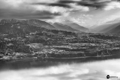 Scenic view of lake and mountains against sky