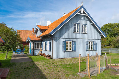 House by building against sky