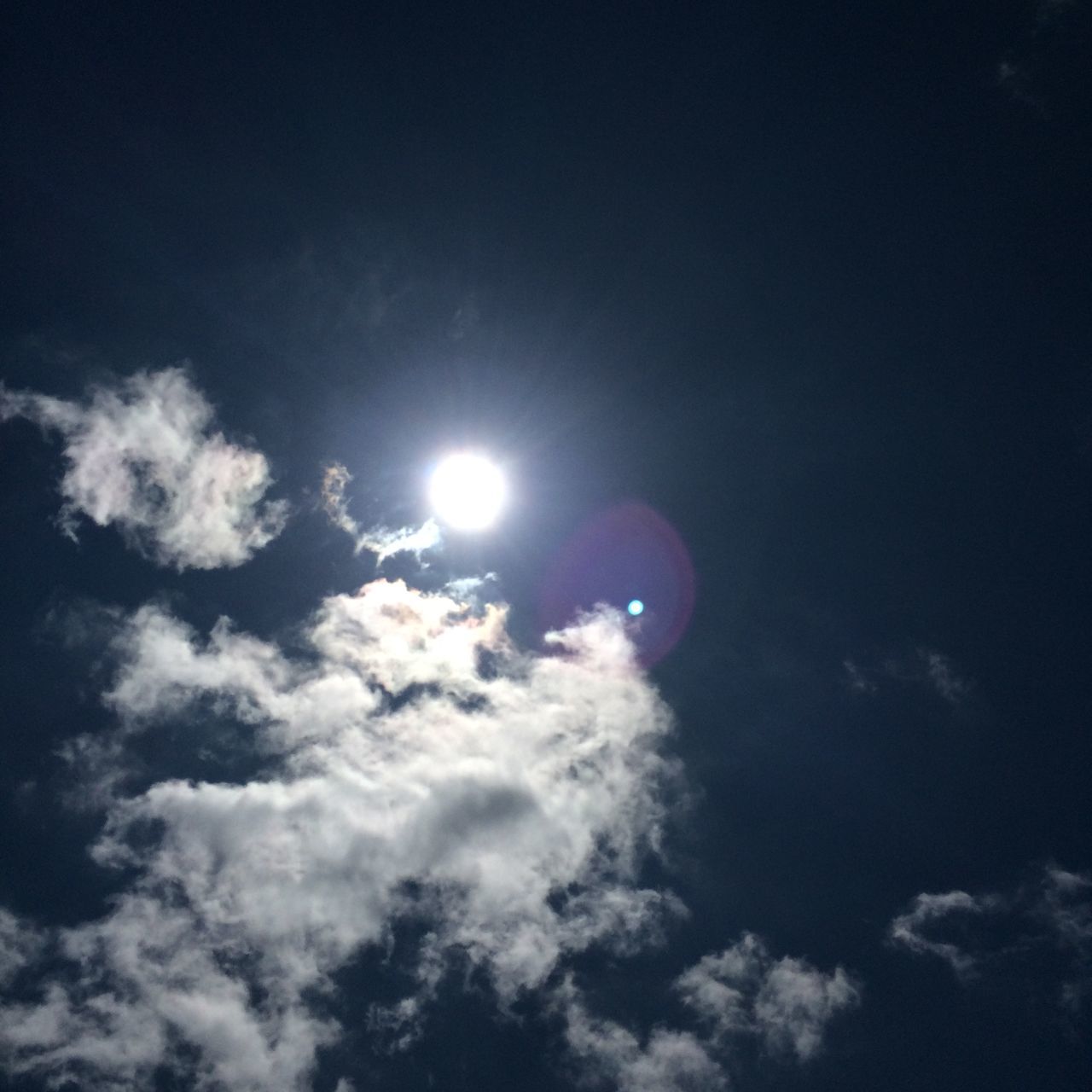 sun, low angle view, sunbeam, sky, sky only, lens flare, beauty in nature, sunlight, tranquility, scenics, nature, blue, cloud - sky, bright, tranquil scene, idyllic, outdoors, no people, sunny, moon