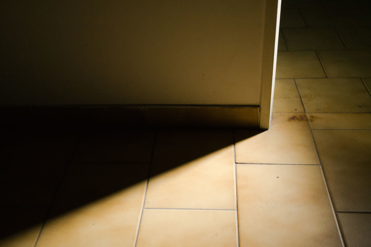 HIGH ANGLE VIEW OF TILED FLOOR BY BUILDING