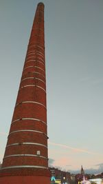 Low angle view of smoke stack against sky