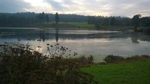 Scenic view of lake against sky during sunset