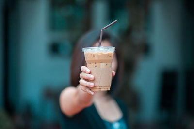 Close-up of hand holding ice cream cone