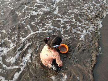 High angle portrait of child in sea