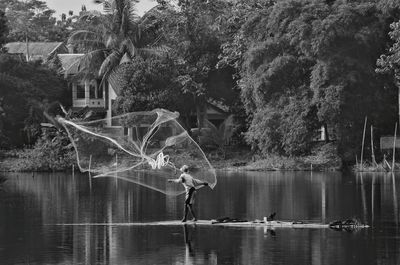 Full length man fishing in lake