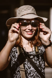 Portrait of smiling young woman wearing sunglasses