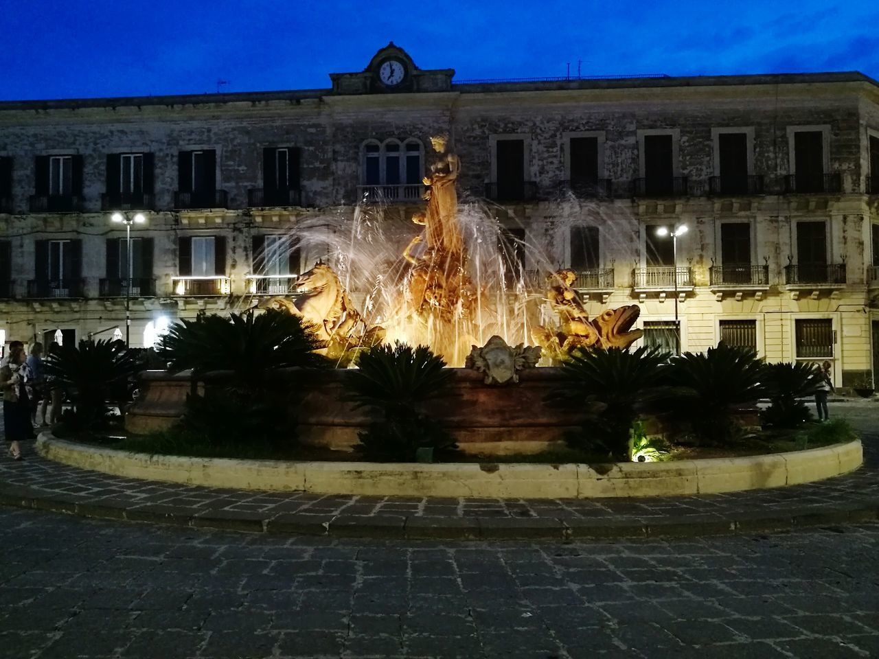 ILLUMINATED FOUNTAIN IN FRONT OF BUILDING