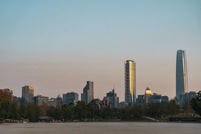 Modern buildings in city against clear sky