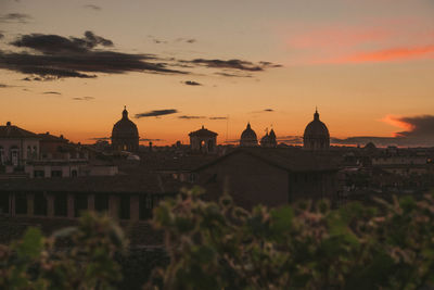 Buildings in city during sunset