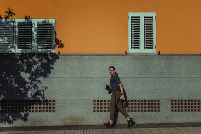 Portrait of man on window in city