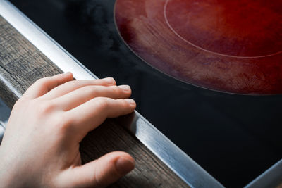 High angle view of person hand on table