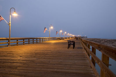 Pier over sea against clear sky