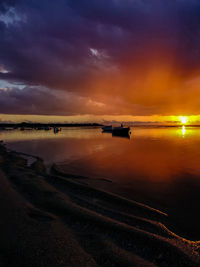 Scenic view of dramatic sky over sea during sunset