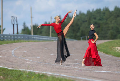 Full length of woman standing on road