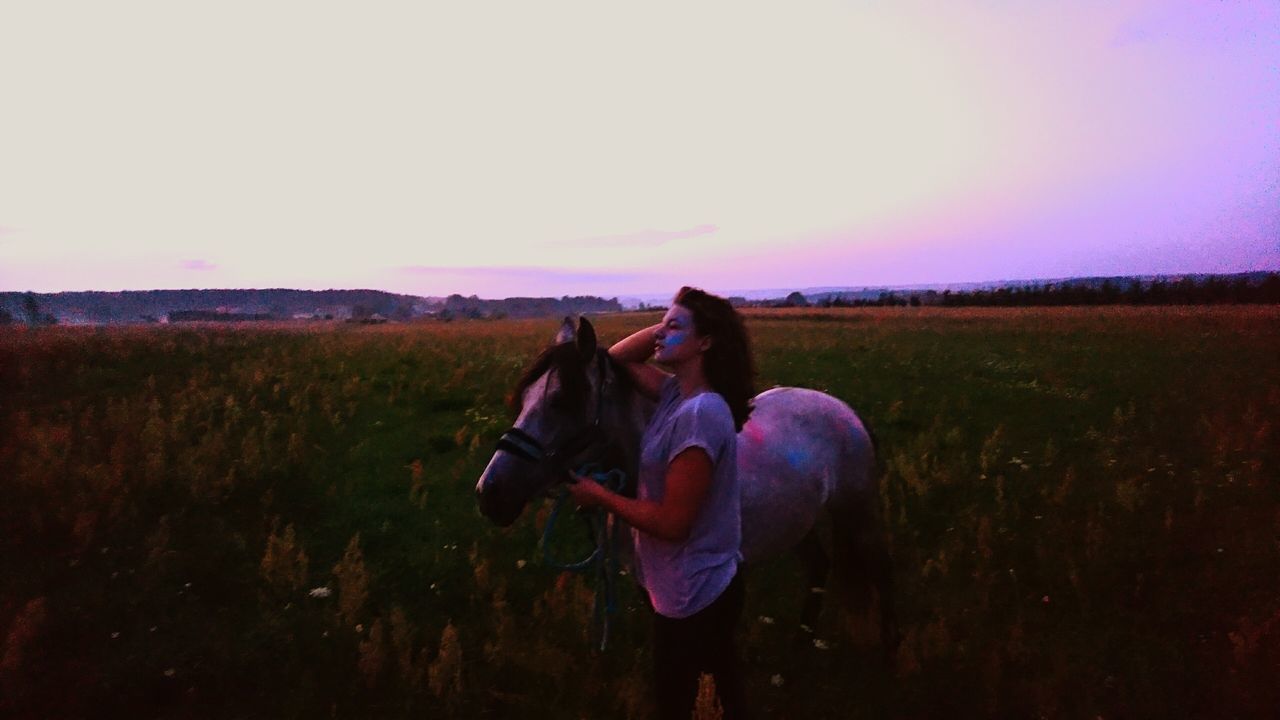 field, grass, lifestyles, leisure activity, landscape, full length, casual clothing, sky, grassy, rural scene, nature, tranquility, beauty in nature, tranquil scene, outdoors, scenics, horizon over land