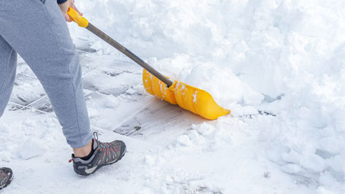 Low section of man skiing on snow