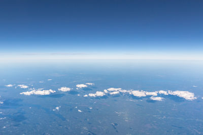 Idyllic view of clouds over landscape against blue sky