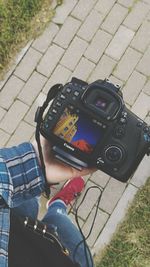 High angle view of man photographing camera