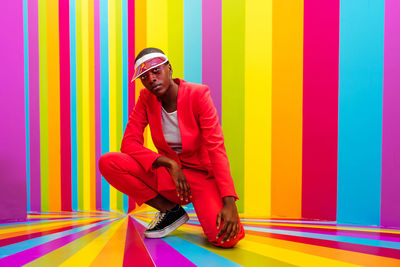 Full length portrait of young man exercising on floor