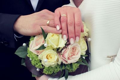 Close-up of couple holding bouquet