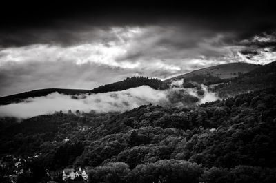 Scenic view of mountains against cloudy sky