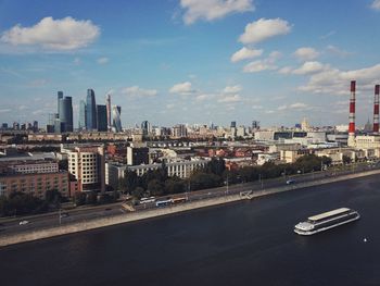 View of cityscape against cloudy sky