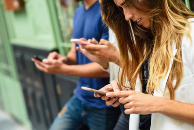 Midsection of woman using mobile phone